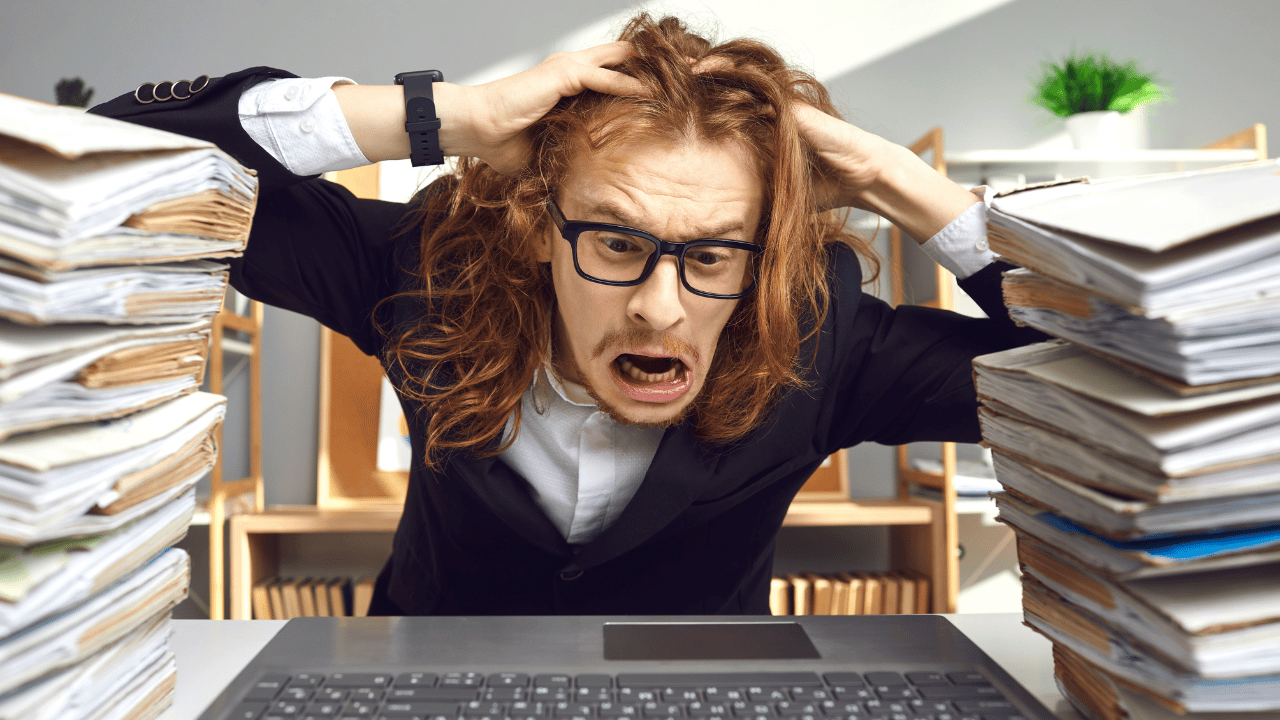 A-stressed-business-owner-at-a-desk_-surrounded-by-tax-documents-and-a-laptop_