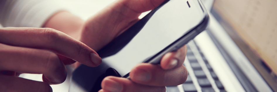A person checking phone for a text message