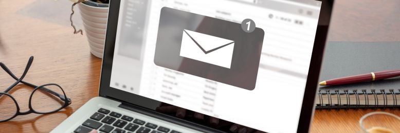 Person checking an email notification on a laptop, representing DMARC email verification