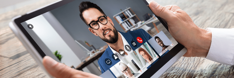 A person holding a tablet in a video conference