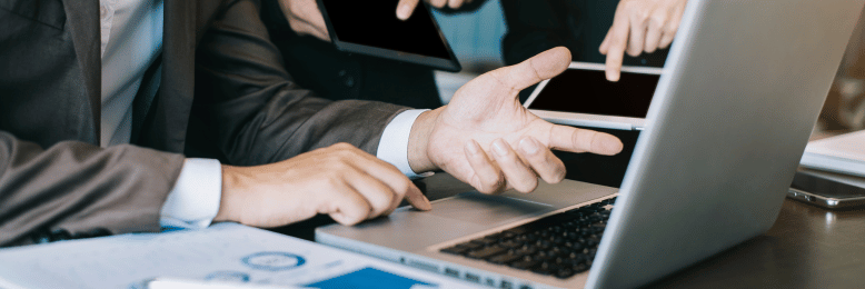 Business colleagues collaborating on laptop for IT service packages