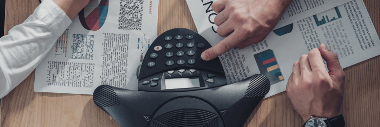 Business professionals framing a contract, discussing VoIP service agreements