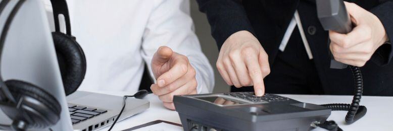 Business professionals setting up 3CX VoIP systems, exploring features during a team meeting