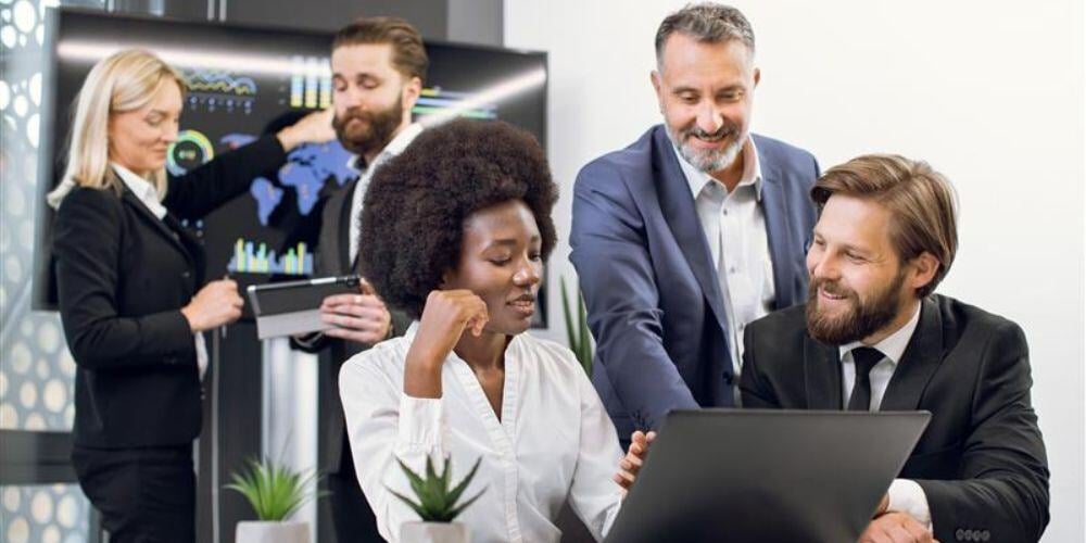 Business team collaborating on IT solutions, highlighting the benefits of exploring new MSPs even with existing IT partners.