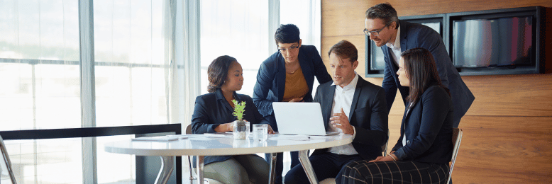 Corporate team in a meeting discussing differences between SOC 2 Type 1 and Type 2 compliance