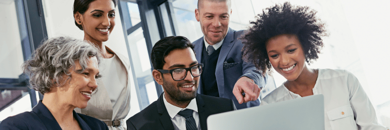 Diverse business team collaboratively solving technology challenges on a laptop for 2024