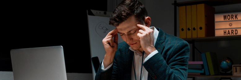 Focused man experiencing stress while managing data backup tasks at night