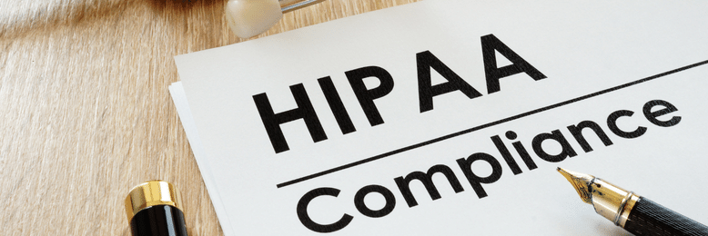 HIPAA Compliance printed on a paper with a pen on top