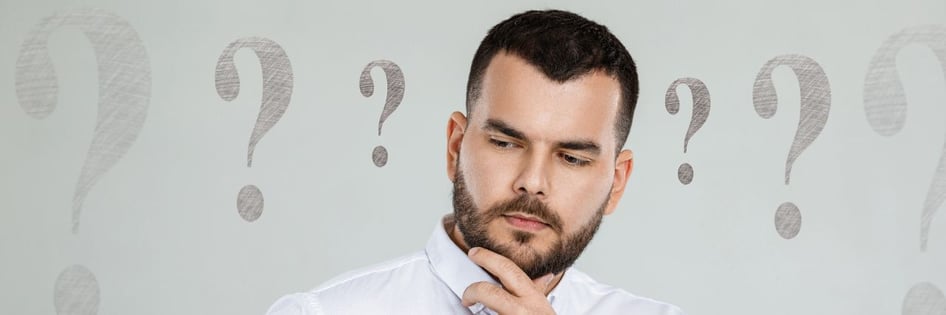 a person with multiple question marks around him
