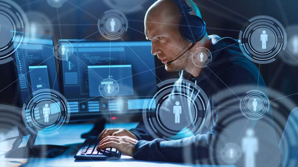 Analyst monitoring network threats across multiple screens