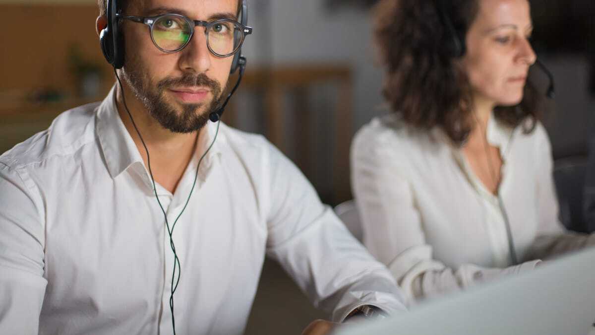 IT support agents on headsets helping customers
