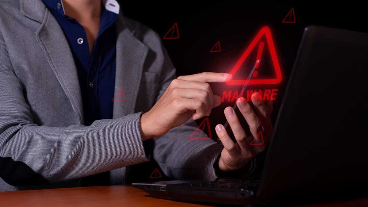 Employee seeing a malware warning on a laptop