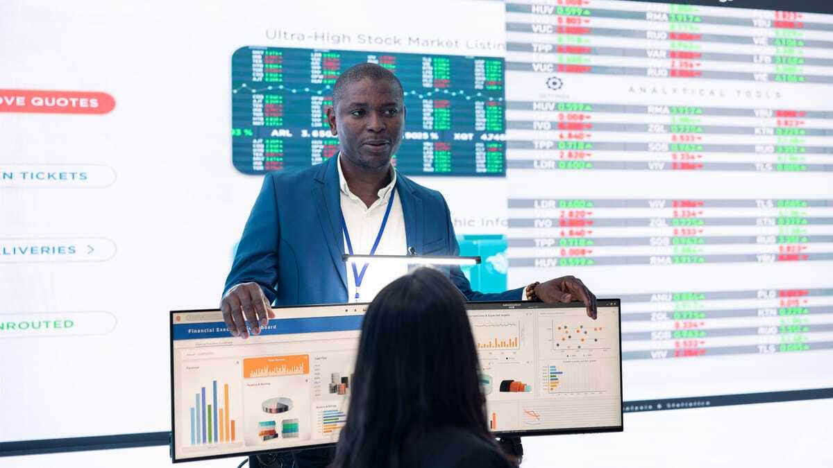 Business team discussing data on a large dashboard