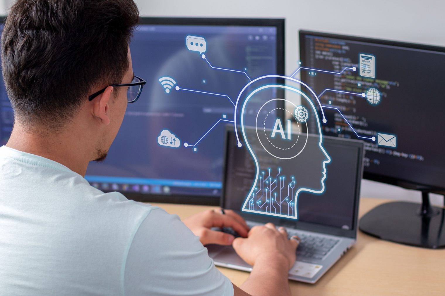 A person at a multi-monitor desk working alongside an AI assistant interface, standing in for work rebuilt around AI