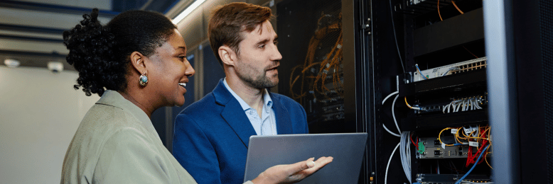 IT professionals at a data center, functioning as vendor liaisons, discussing server management