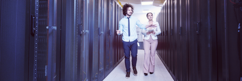 IT professionals discussing data backup solutions in a server room