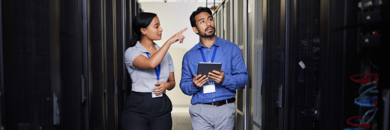 IT professionals discussing server migration strategy in a server room