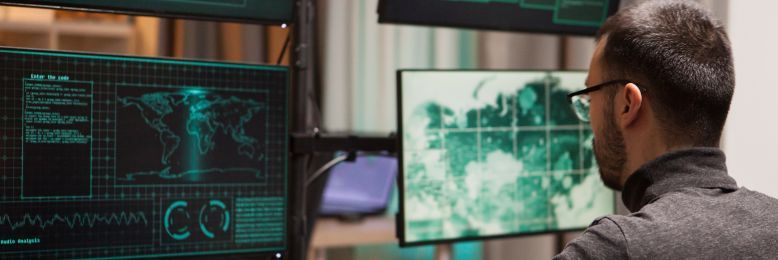 Male security analyst using advanced systems to run a vulnerability scan in a control room
