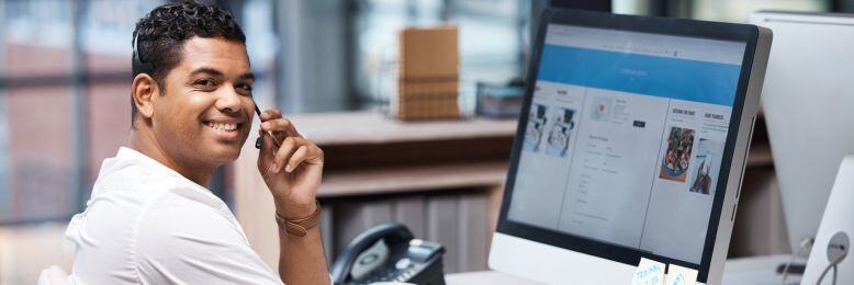 Man in office reviewing 3CX VoIP interface, enhancing communication efficiency for his team