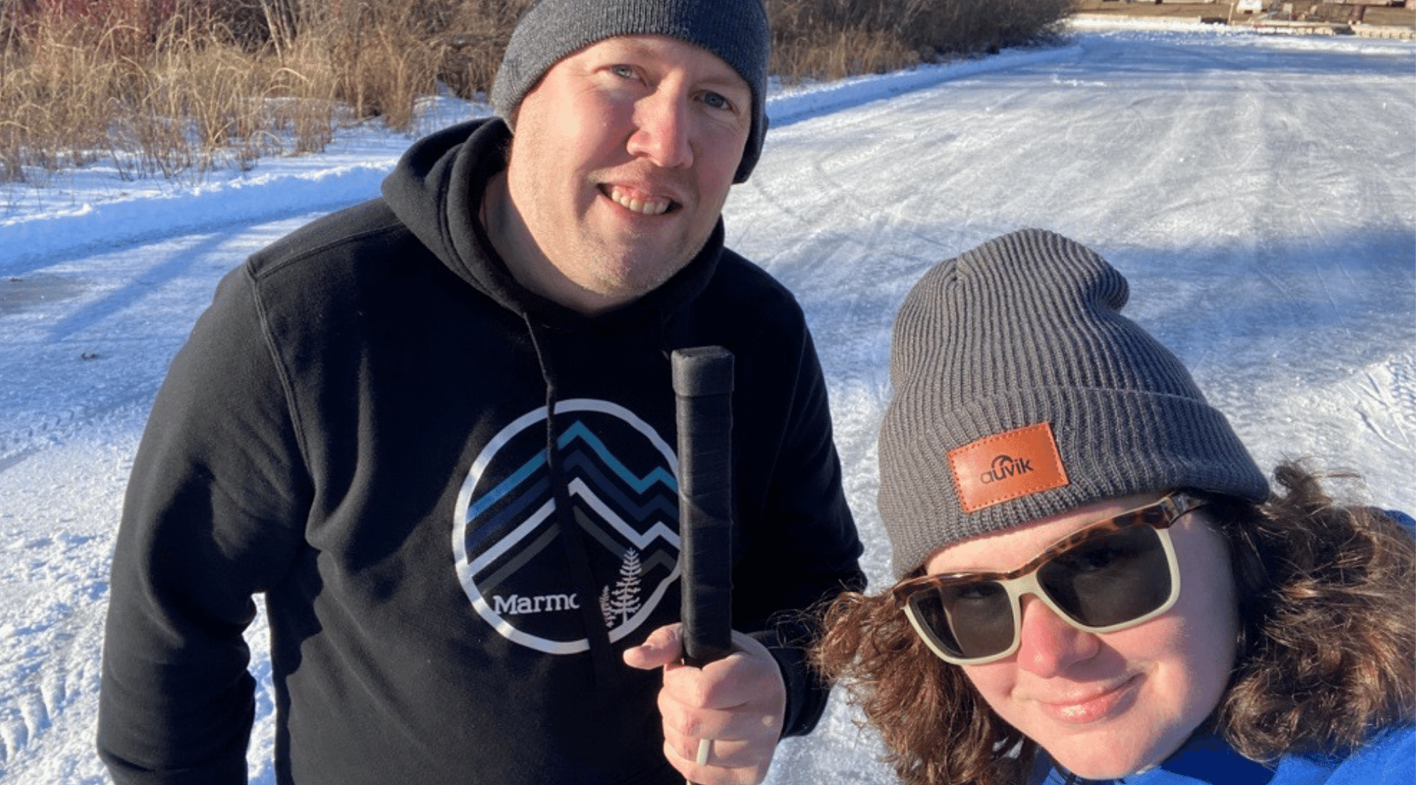 Meghan and her husband playing hockey on frozen lake