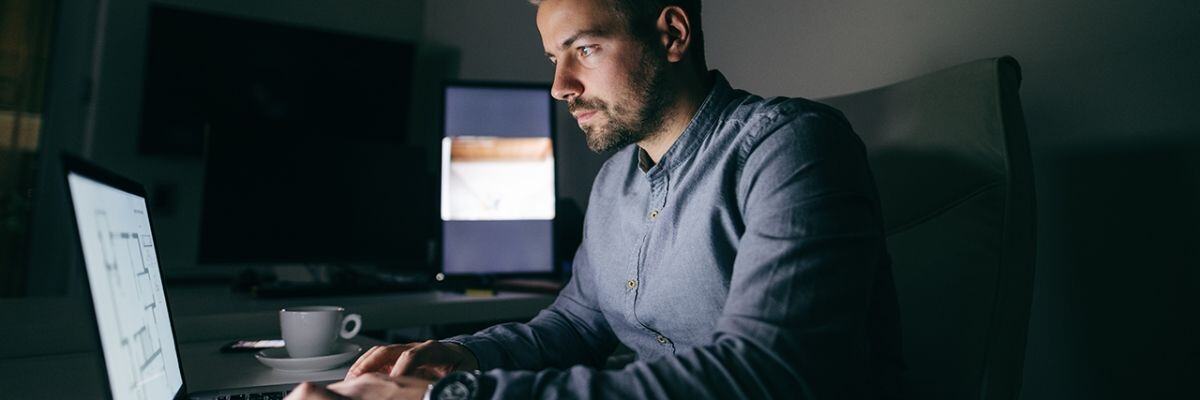 Focused IT professional working late hours, representing the dedicated services of MSPs worth the investment