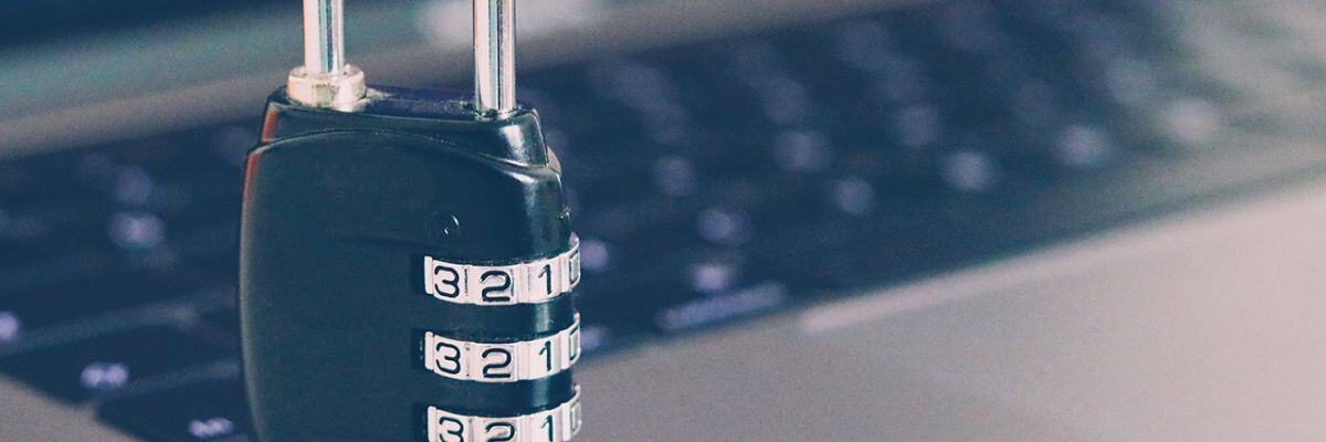 A padlock with a laptop on the background