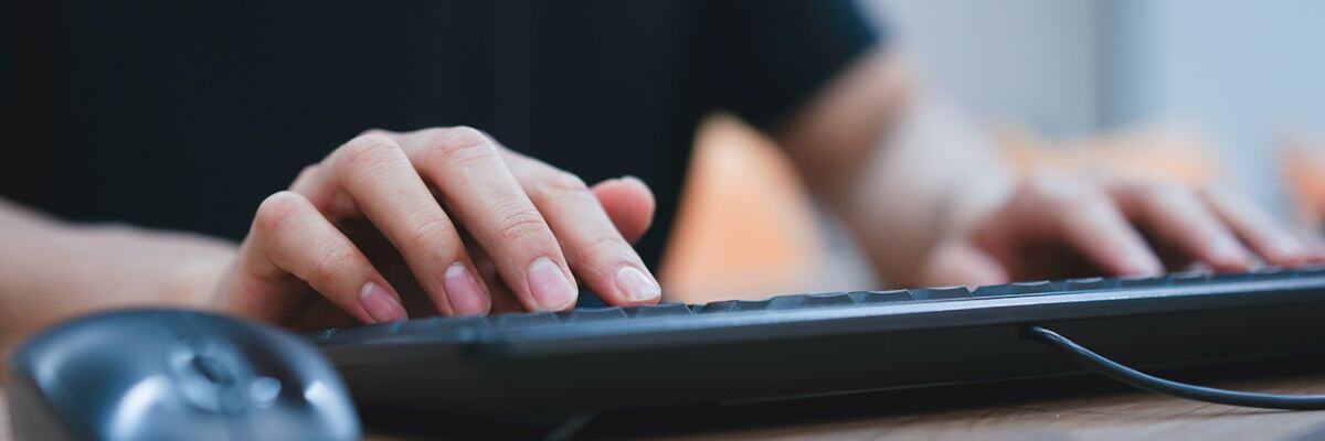 A person typing on the keyboard
