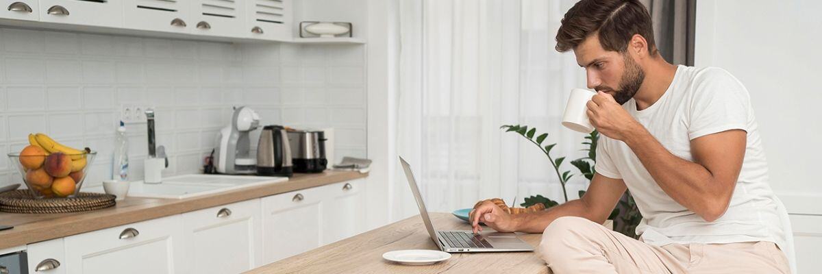 A person drinking coffee while working from home