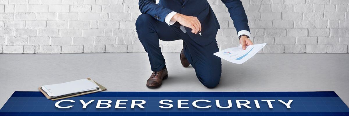 Cyber security written on the floor with a man standing over it