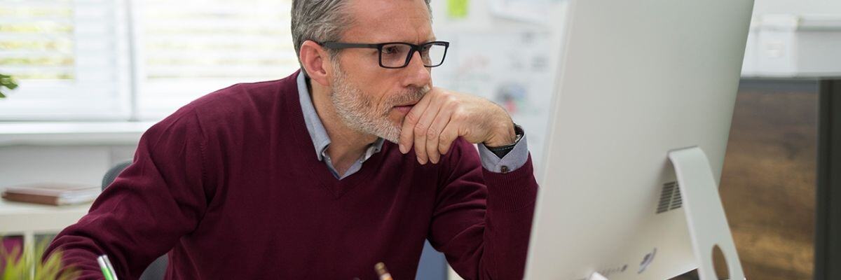 a man working looking intently on his monitor