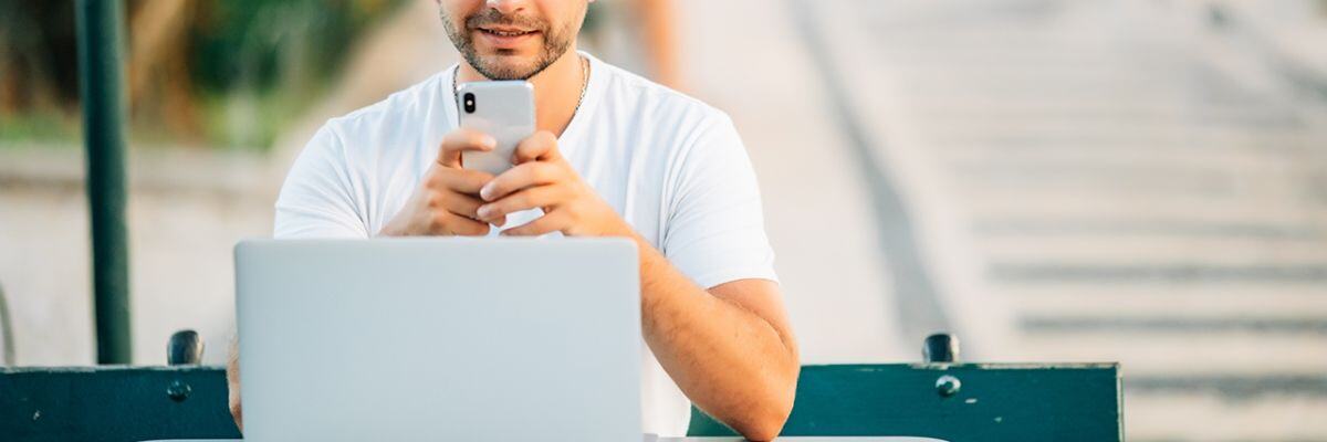 a man with his phone and laptop