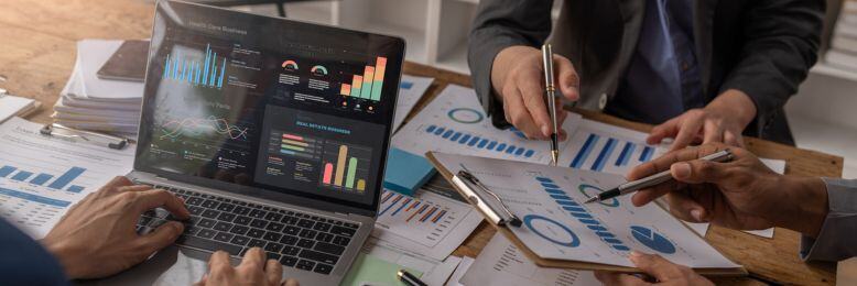 Professionals engaged in strategic planning over potential downsides of underfunded IT services