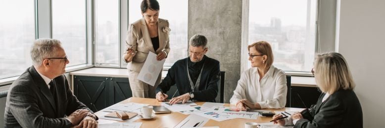 Leadership team reviewing policies and processes, highlighting change management challenges in SOC 2 readiness.