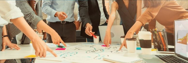 Business team mapping an IT roadmap to prevent constant firefighting and improve strategic technology planning.