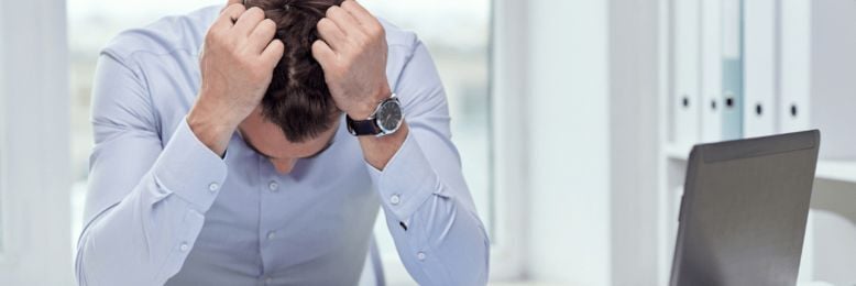 Frustrated business leader overwhelmed by IT issues, illustrating why good IT support eliminates constant management.