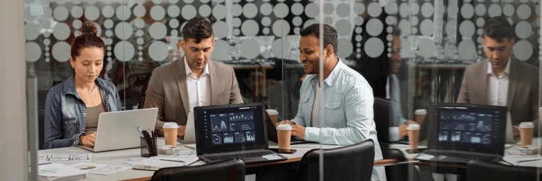 Team meeting in a modern office discussing co-managed IT cost strategies