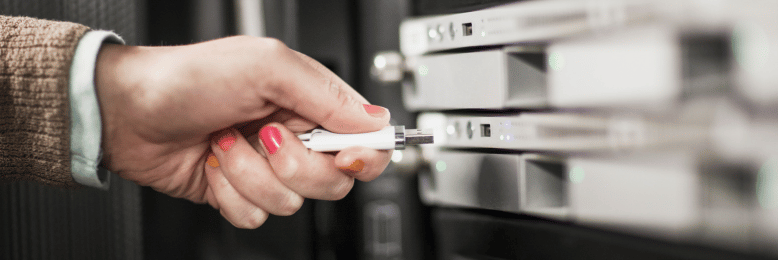 Technician inserting USB for data transfer, a method for sending large files for businesses