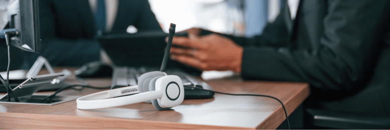 Two colleagues with VoIP equipment, engaging in contract negotiations