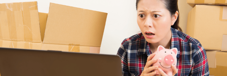 Worried business owner holding a piggy bank