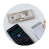 a calculator, money and notepad for budgetting