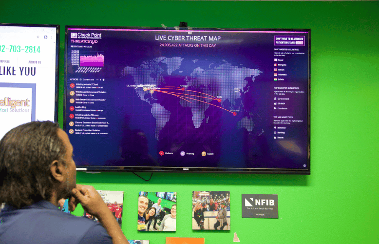 a live cyber threat map being monitored by a technician
