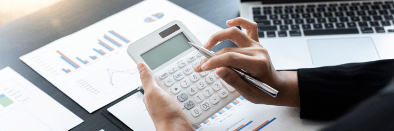 a person holding a calculator going over the budget