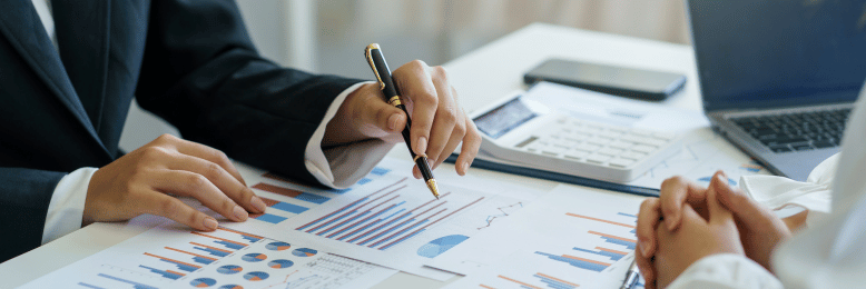 a person pointing out data using a pen