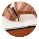 a person writing something on a notebook