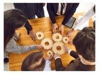 a team putting together gears to make it work