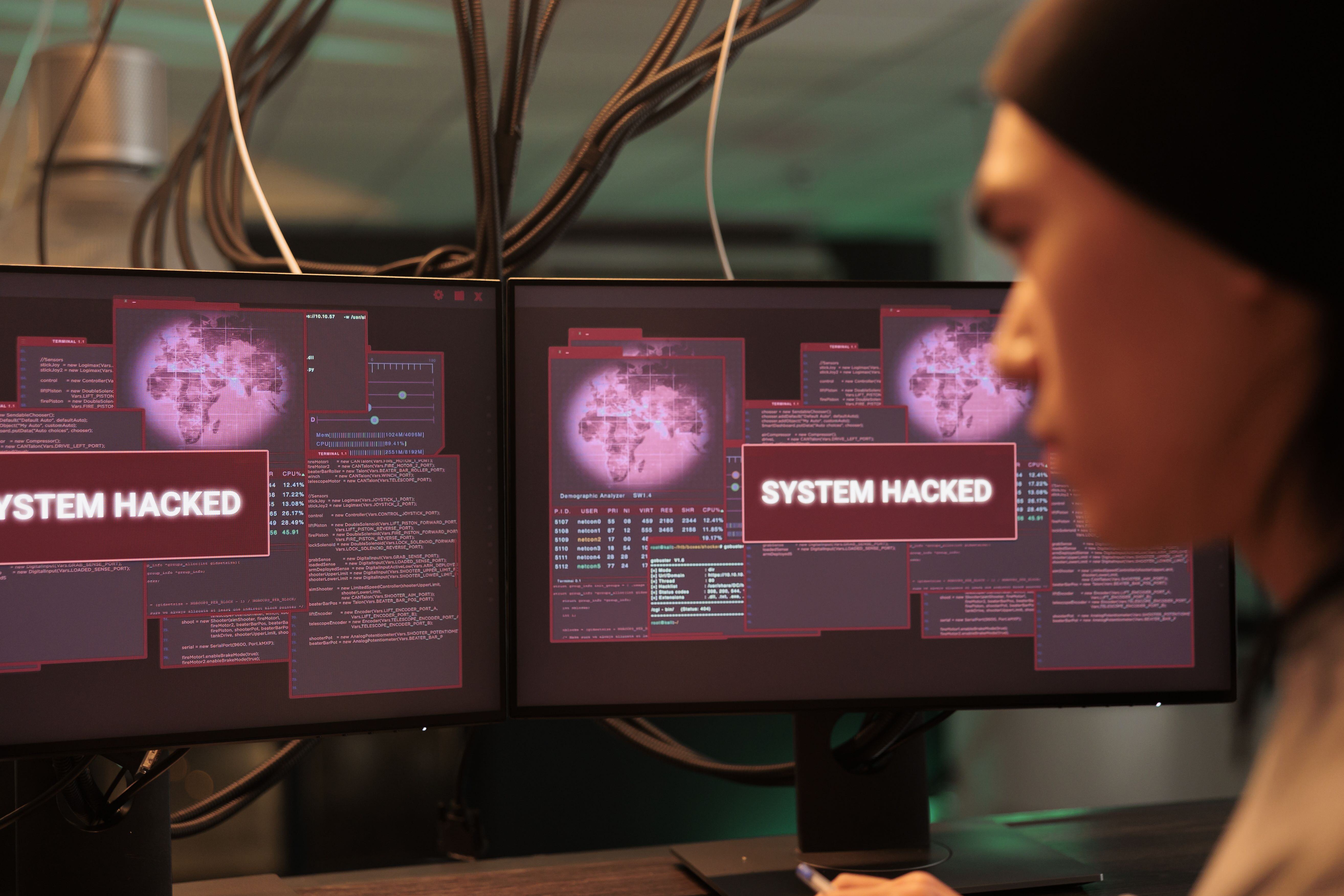 asian-thief-analyzing-encryption-alert-on-monitors-2023-11-27-05-33-34-utc