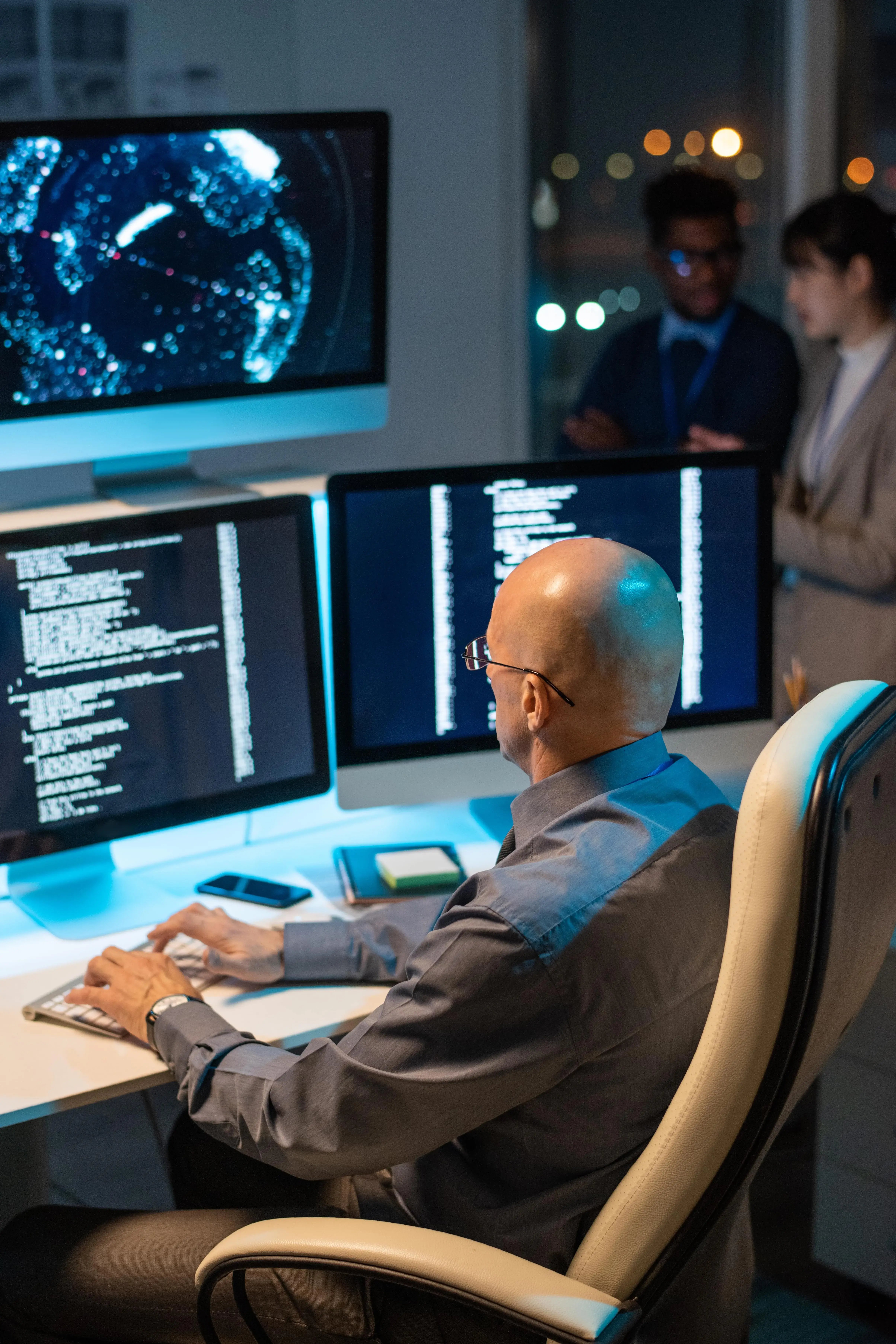 bald-mature-businessman-decoding-data-on-computer-2025-03-13-23-53-00-utc-min