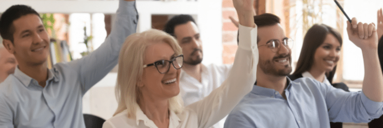 employees raising their hands in training