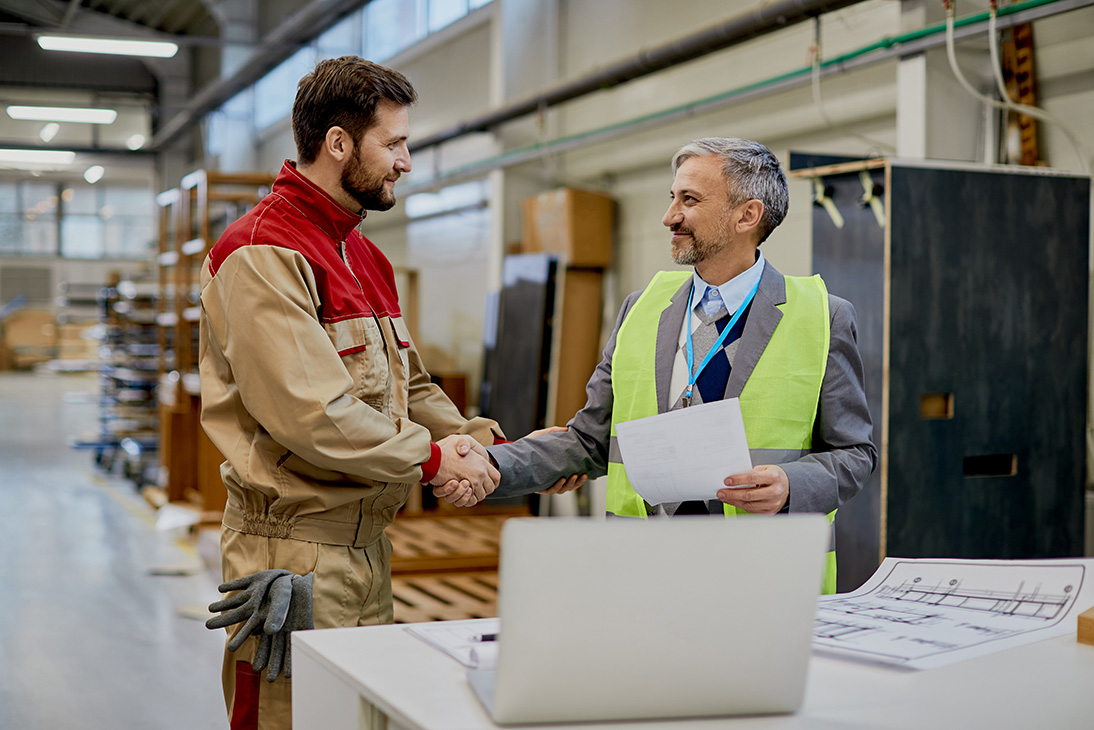Woodworker and company management shaking hands