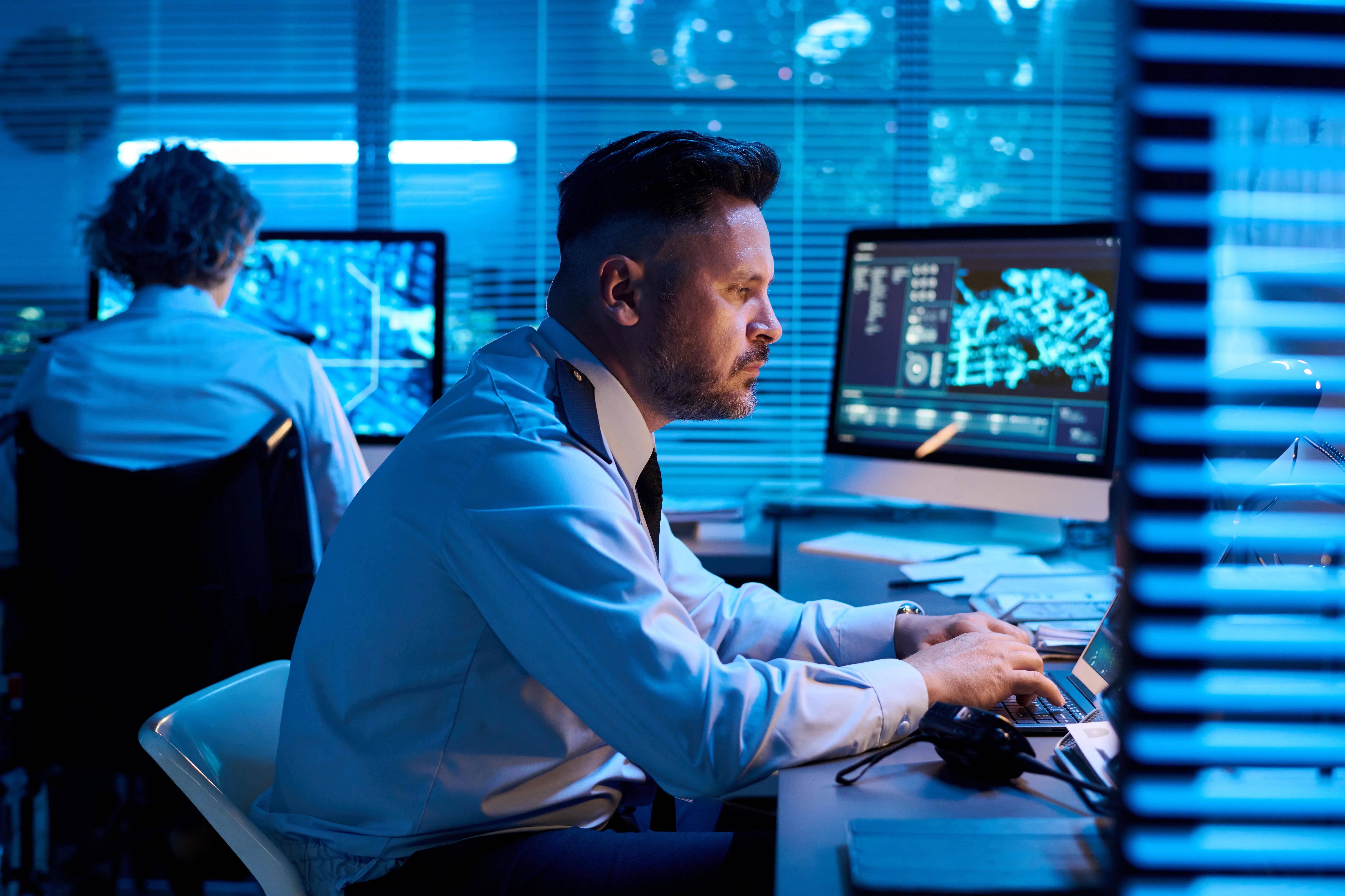 man-looking-at-laptop-screen-and-typing-2025-03-15-23-03-04-utc-min